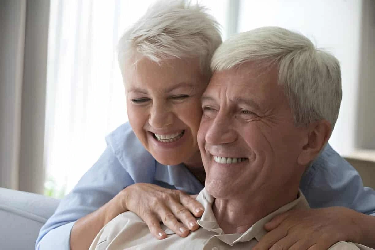 Happy senior couple embracing and smiling together