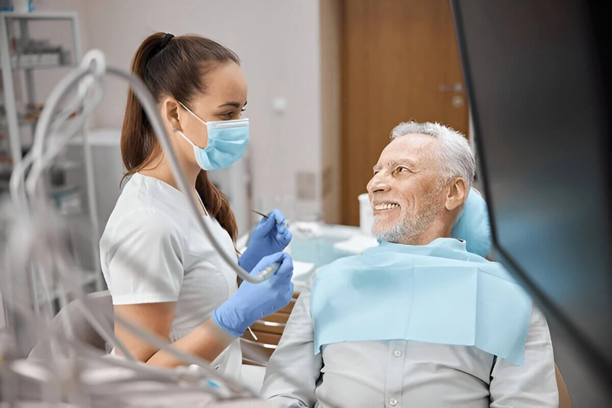 Senior man smiling at his dentist during a checkup